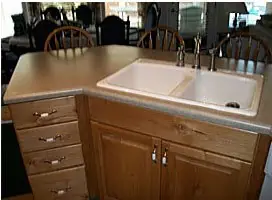 Tan solid-surface kitchen counter with a double sink
