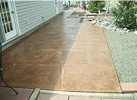 Long walkway beside a house resurfaced in a tan and brown overlay