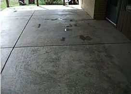 Plain stained grey concrete patio slab before resurfacing