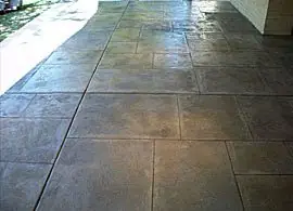 Covered patio after resurfacing in a grey slate-tile pattern