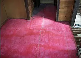 Interior concrete slab with a red color coat going down