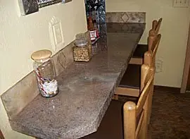 Bar-height counter in a grey and brown stone-look overlay