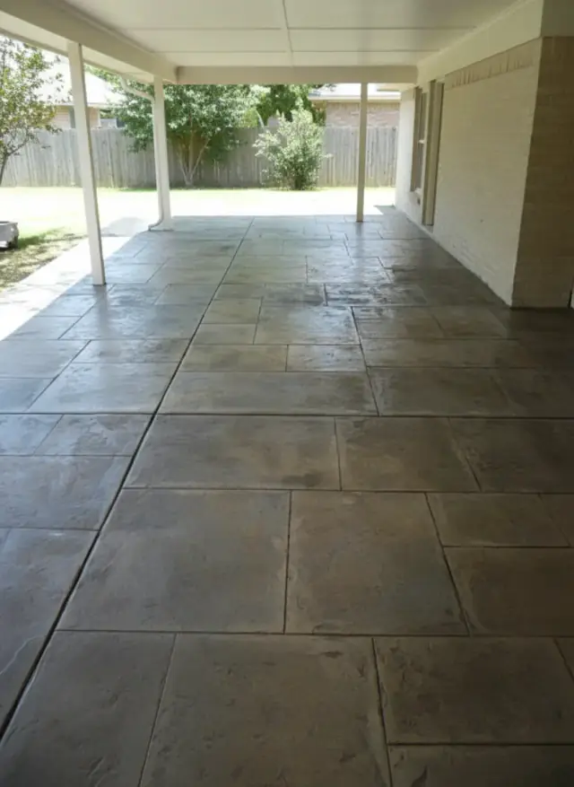 Covered back patio resurfaced in a grey slate-tile pattern overlay